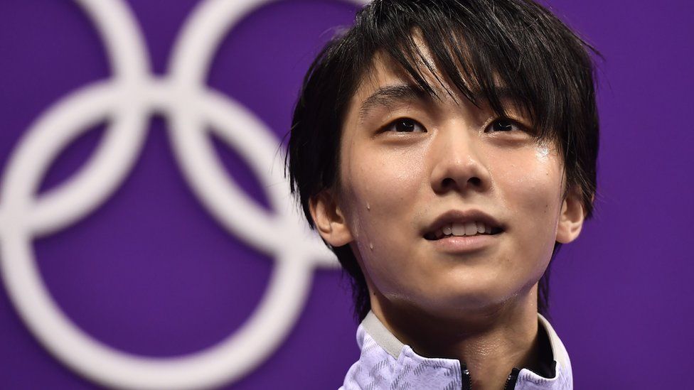 Japan's Yuzuru Hanyu reacts after judges awarded him an Olympic-record score