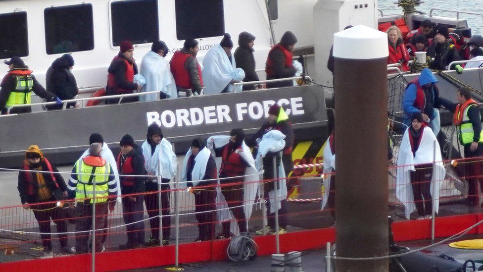 A group of people thought to be migrants are brought in to Dover, Kent on 28 November