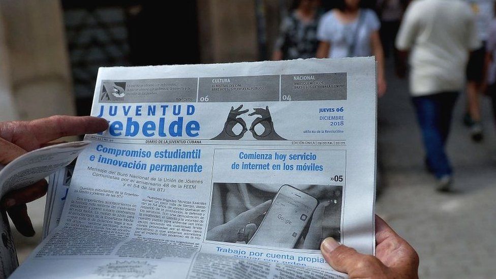 A man reads a newspaper in Havana