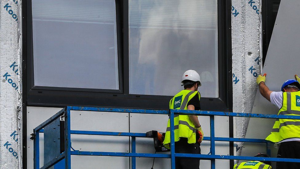 Cladding being removed for a tower in Manchester