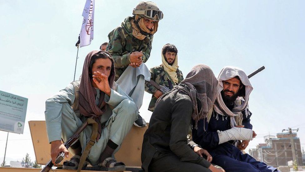 Taliban fighters are seen on the back of a vehicle in Kabul, Afghanistan, 16 August 2021