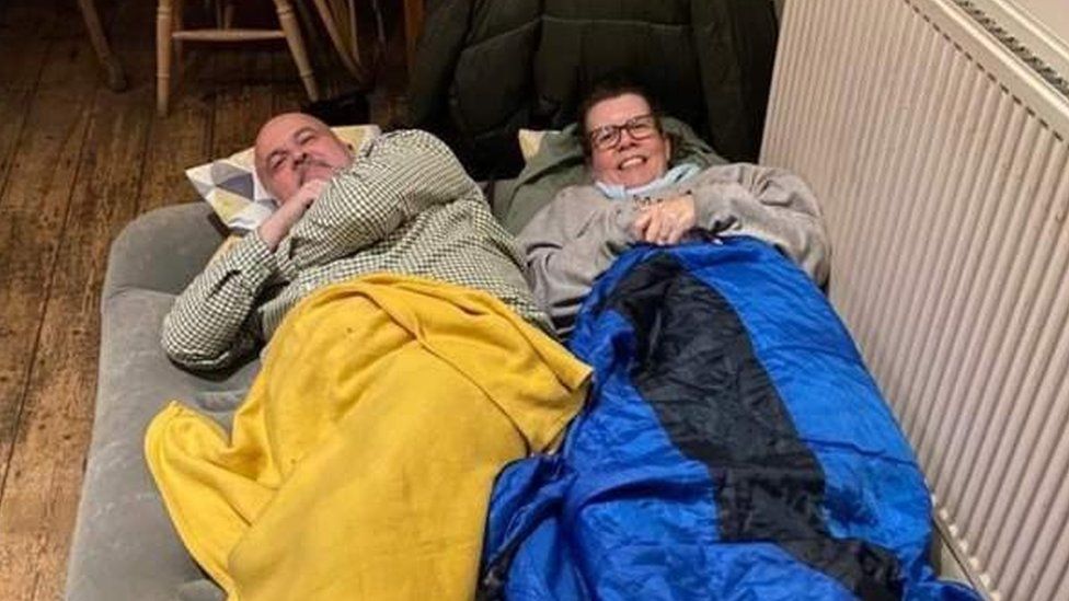 Kevin and Paula Gleed in sleeping bags on an air bed