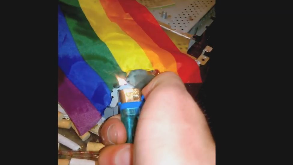 Ethan Stables setting fire to a rainbow flag