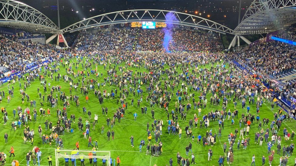 Fans on the pitch at Huddersfield