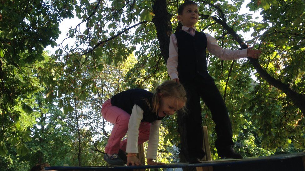 Olga Makarenko's son and daughter play at a park in Ukraine, September 2015
