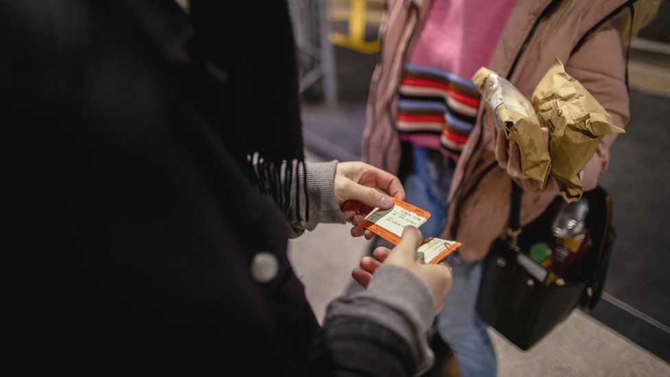 Inspector checking a passenger's bid     ticket