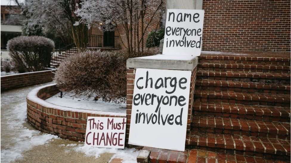 Signs outside Nichols' funeral call for more charges