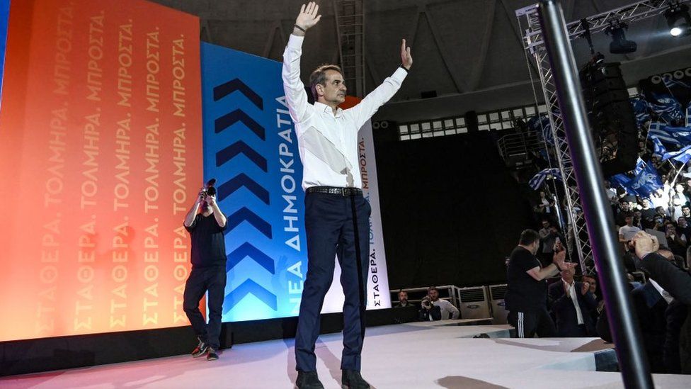 Greek Prime Minister Kyriakos Mitsotakis, leader of the conservative New Democracy party, gestures as he greets his supporters during the party's main campaign rally in Thessaloniki on May 18, 2023