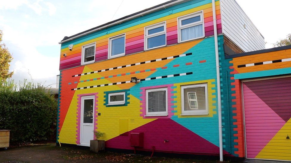A colourful building with multiple levels of colour