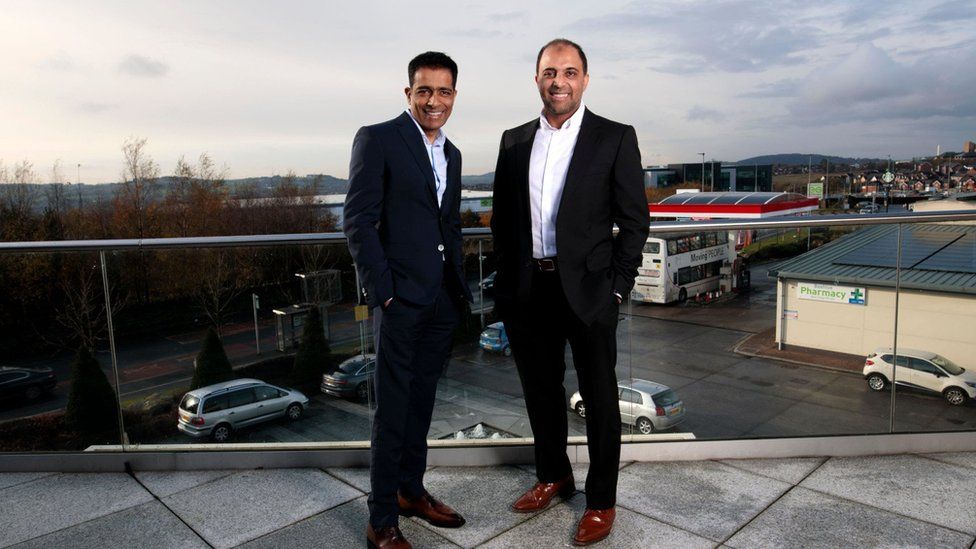 Mohsin and Zuber Issa pose on a balcony in Blackburn