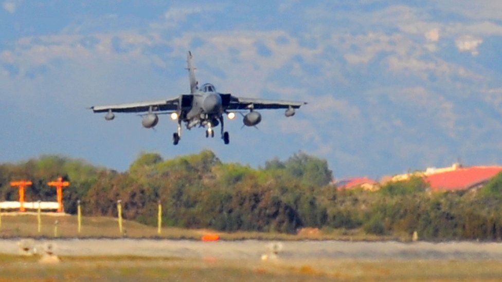 An RAF Tornado GR4, with remaining weapons ordnance, comes into land through the heat haze, at RAF Akrotiri in Cyprus, as it returns to the base after carrying out some of the first British bombing runs over Syria.