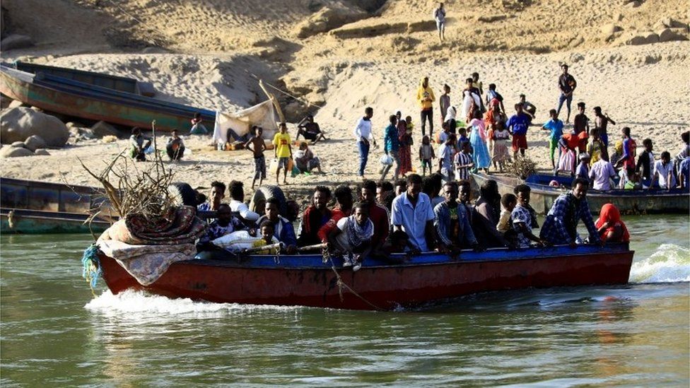 Ethiopians who fled the ongoing fighting in Tigray region, use boats to cross the Setit river on the Sudan-Ethiopia border in Hamdayet village in eastern Kassala state, Sudan November 22, 2020