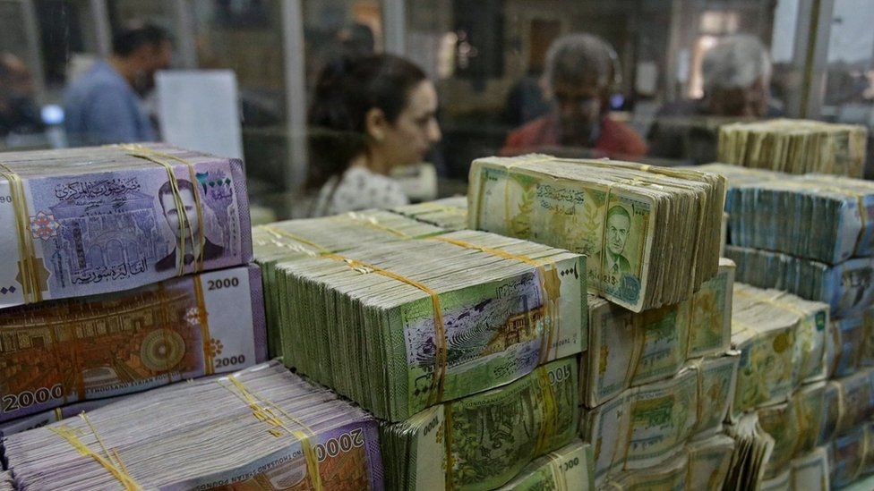 File photo showing stacks of Syrian pound notes at the Commercial Bank of Syria in Damascus, on 10 November 2022