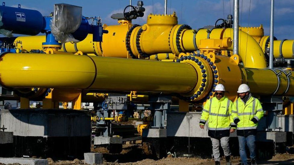 Employees walk at the construction site of a gas metering station, part of the pipeline link between Bulgaria and Greece near the village of the Malko Kadievo, on March 18, 2022