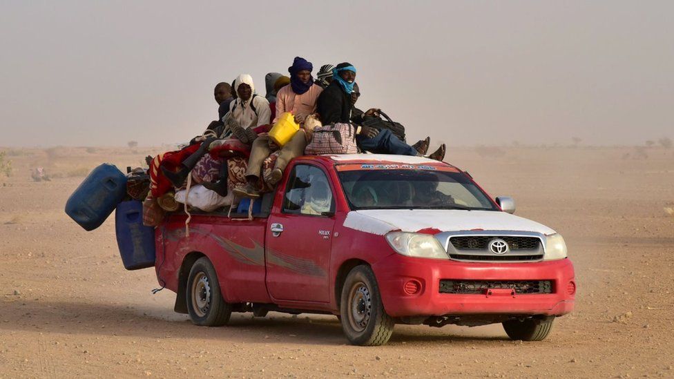 West African people coming back to Niger after fleeing Libya due to armed groups, arrive on a pick up in Agadez, northern Niger, on March 31, 2017,