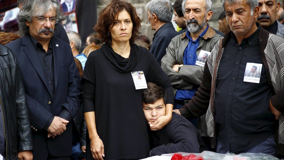 Emel Kitapci (2nd L) and Artun Siyah Kitapci, the wife and son of Ali Kitapci, a victim of Saturday's bomb blasts, attend a commemoration in Ankara, Turkey, October 12, 2015.