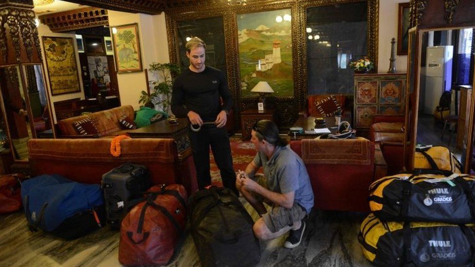 Mountaineers Phil Crampton (right) and Zysle Turner (left) preparing bags in a hotel lobby (01 April 2016)