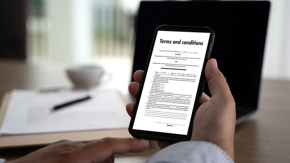 A mobile phone with Terms and Conditions contract on screen