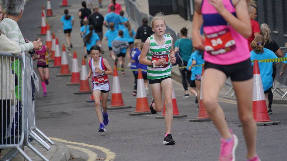 A young girl makes her way around the Junior North Run course