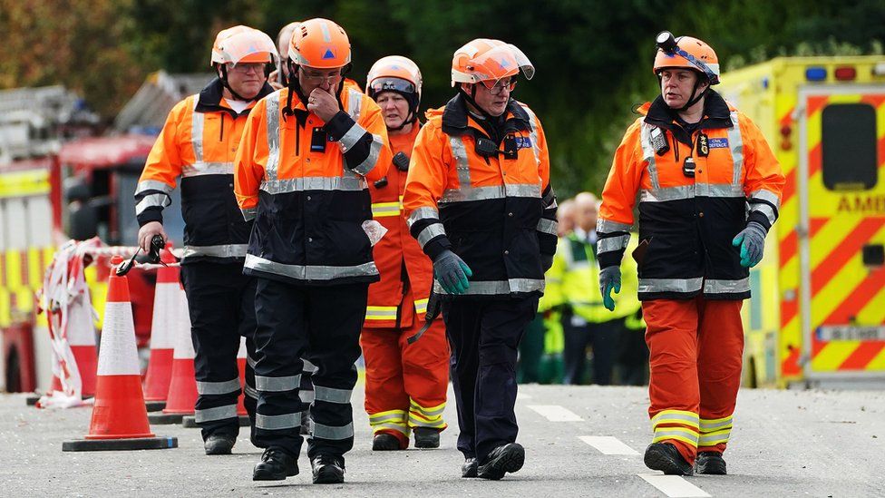 Search and rescue workers leave the scene of the explosion in Creeslough
