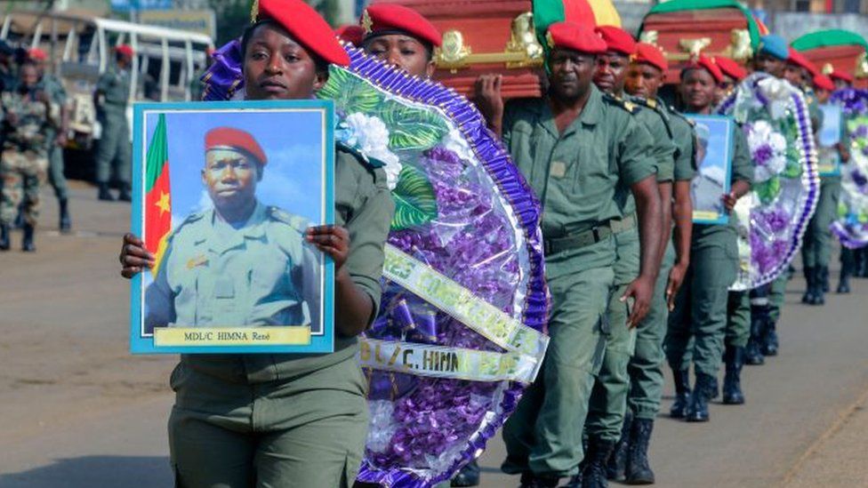 Soldiers carry the coffins of the four soldiers killed in the violence that erupted in the Northwest and Southwest Regions of Cameroon, where most of the country's English-speaking minority live, during a ceremony in Bamenda on November 17, 2017
