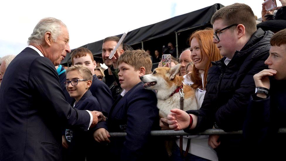 King Charles meets schoolchildren and Connie the corgi outside Hillsborough Castle