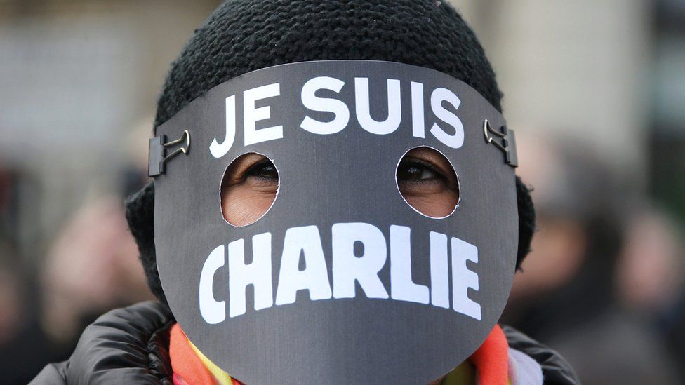 A woman wearing a mask reading "I am Charlie" takes part in a solidarity march in the streets of Paris on 11 January 2015