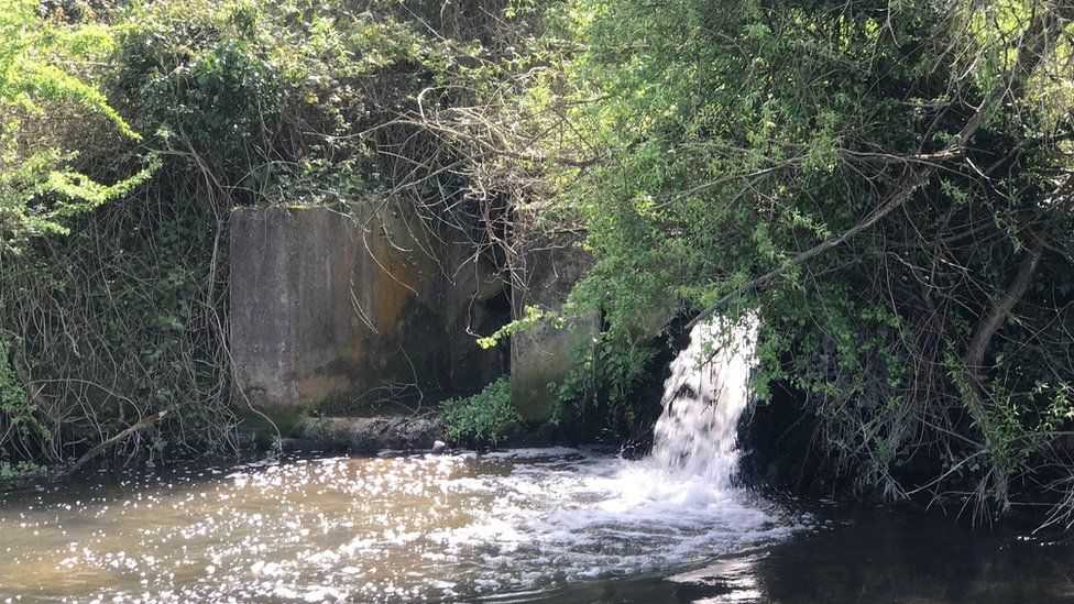Sewage pipe going into River Coln, Fairford in Gloucestershire