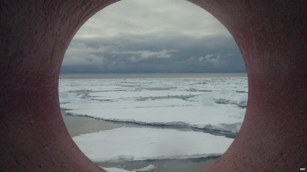 Pack ice view through the circular window of the ship.