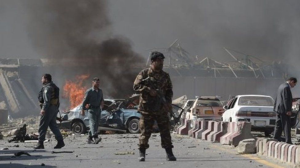 Afghan security force members stand at the site of a blast in Kabul. Photo: 31 May 2017
