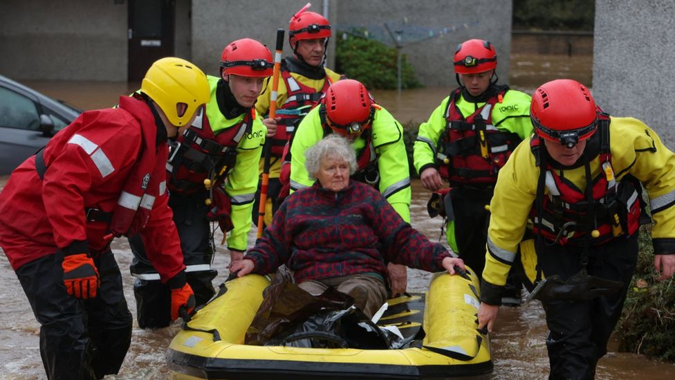 Emergency services assist in the evacuation of people from their homes in Brechin, amid floods during Storm Babet