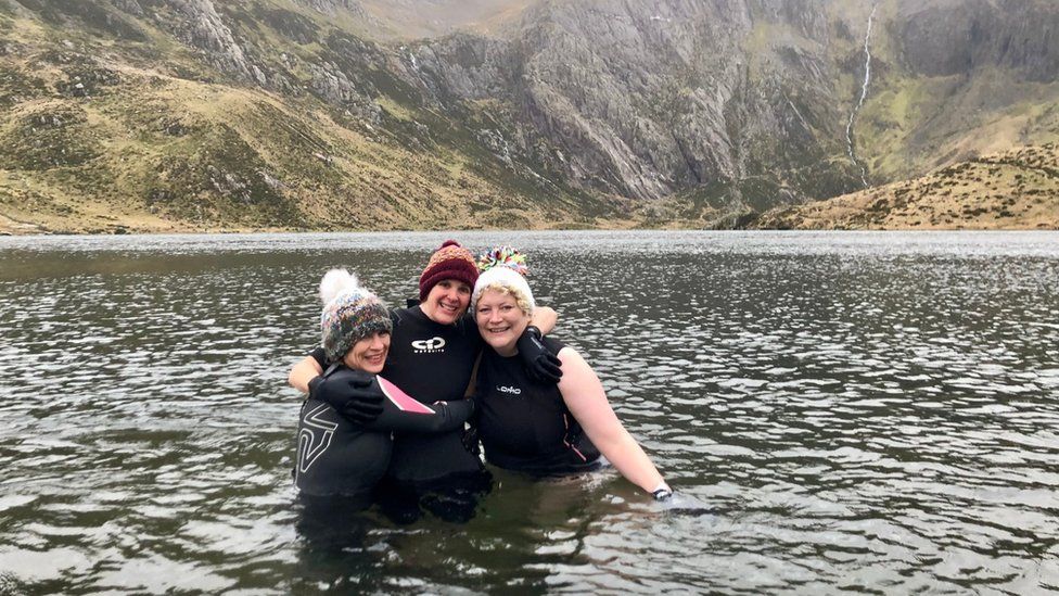 Friends Melissa, Amy and Dawn open water swimming in Wales in 2023