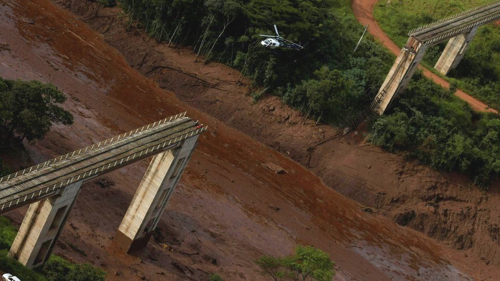 A helicopter flies over a dam owned by Brazilian miner Vale SA that burst, in Brumadinho, Brazil