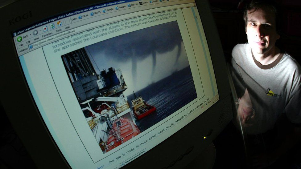 David Mikkelson by his computer monitor with a doctored photo in 2004