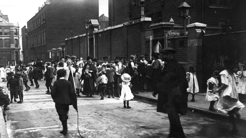 12th September 1911: Mothers collecting children after school during the schoolboy strike in London's East End