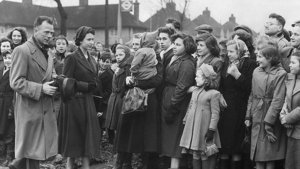 The Queen visits Tilbury, Essex, which was affected by flooding in 1953.