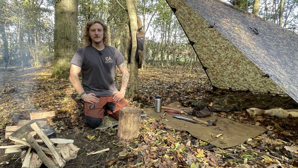 Craig Welsh and bonfire at makeshift camp