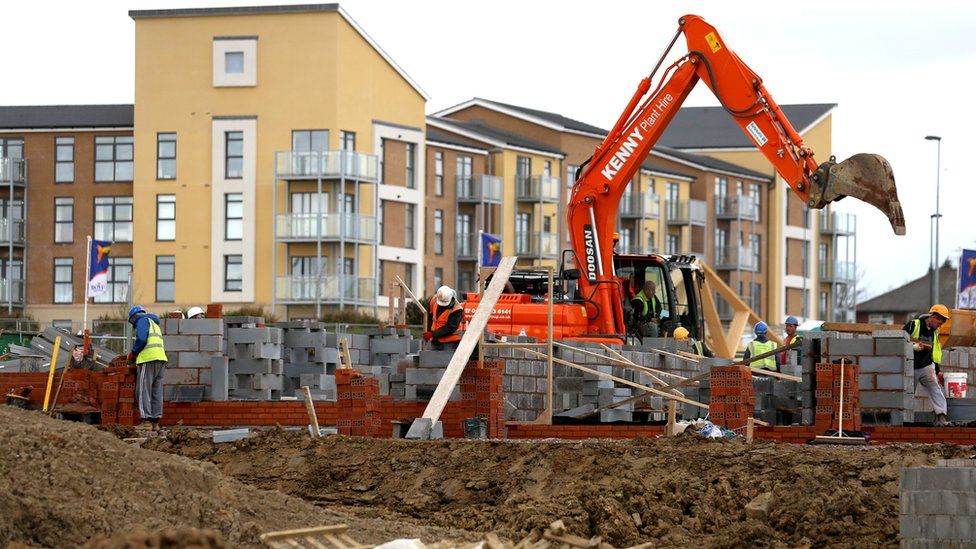 Building site with digger and new homes