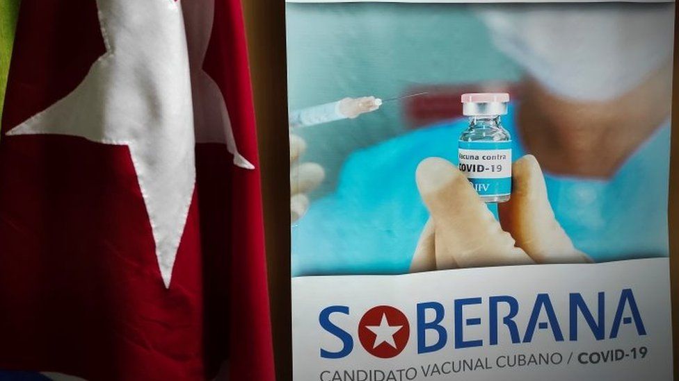 An advertisement poster of Cuba's Soberana 2 Covid-19 vaccine hangs next to the Cuban national flag at the Finlay Institute in Havana, Cuba, 20 January 2021.
