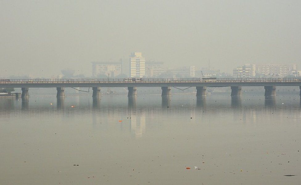 Traffic is pictured on a bridge over the Sabarmati River during heavy smog conditions in Ahmedabad on February 5, 2019.