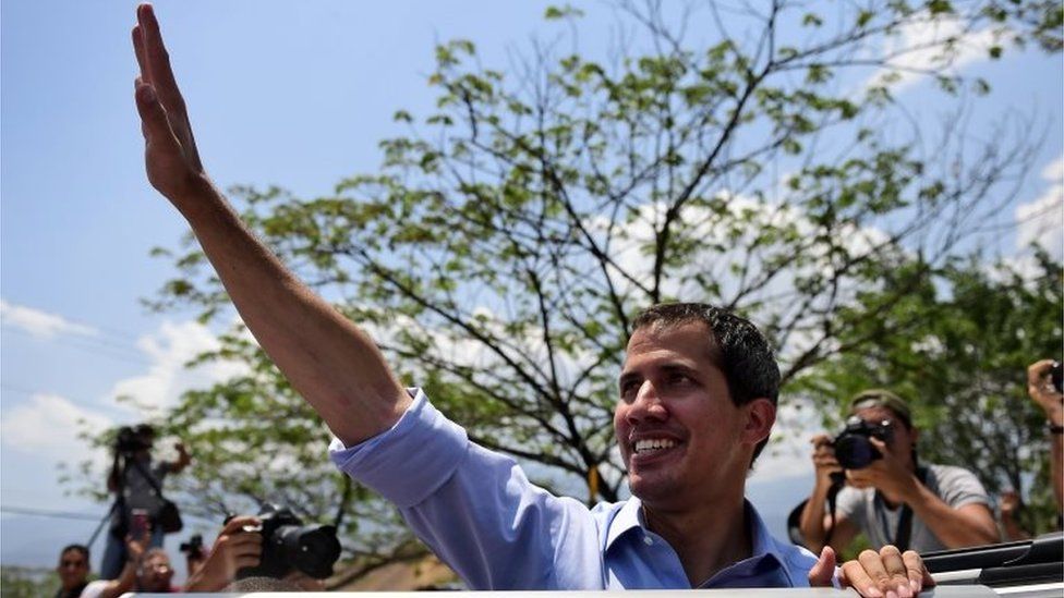 Venezuelan opposition leader and self-declared president Juan Guaido waves to supporters during a rally in Guatire, Miranda state, Venezuela on May 18, 2019.