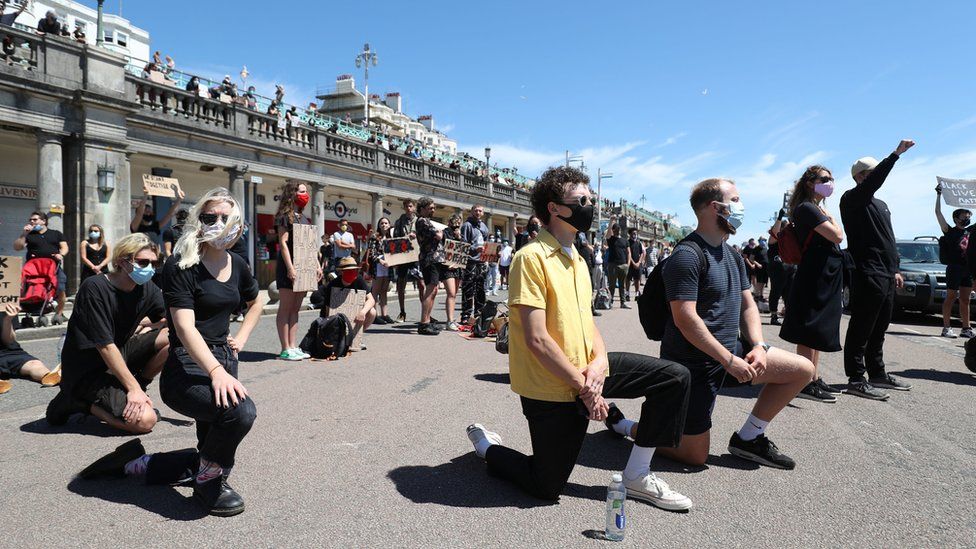 Protesters from Black Lives Matter take part in a silent vigil on Brighton Pier