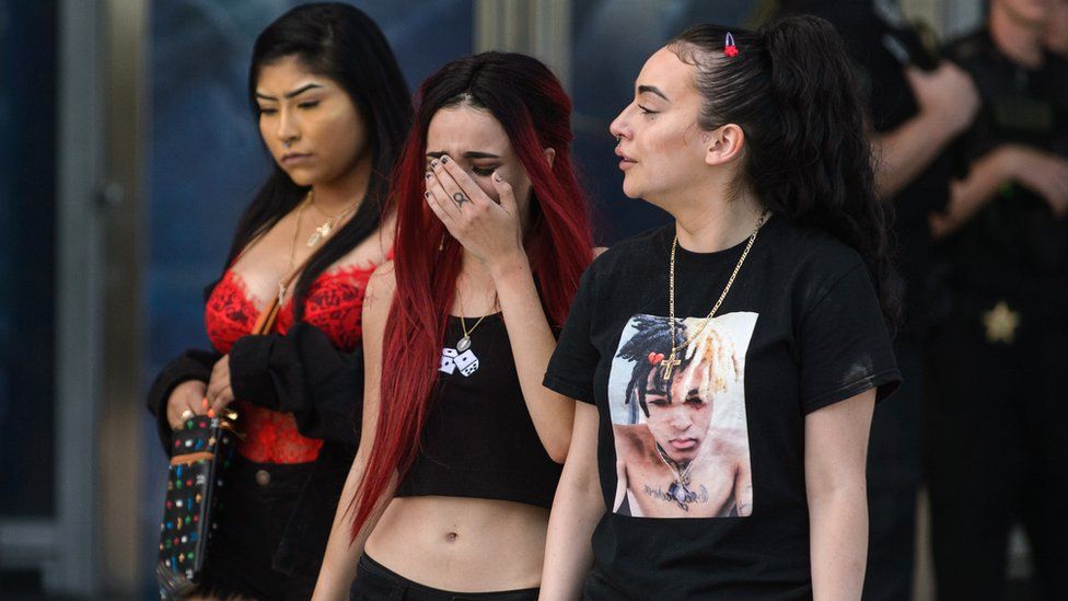 Fans mourn after exiting the XXXTentacion memorial service at the Florida Panther's Stadium, 27 June 2018