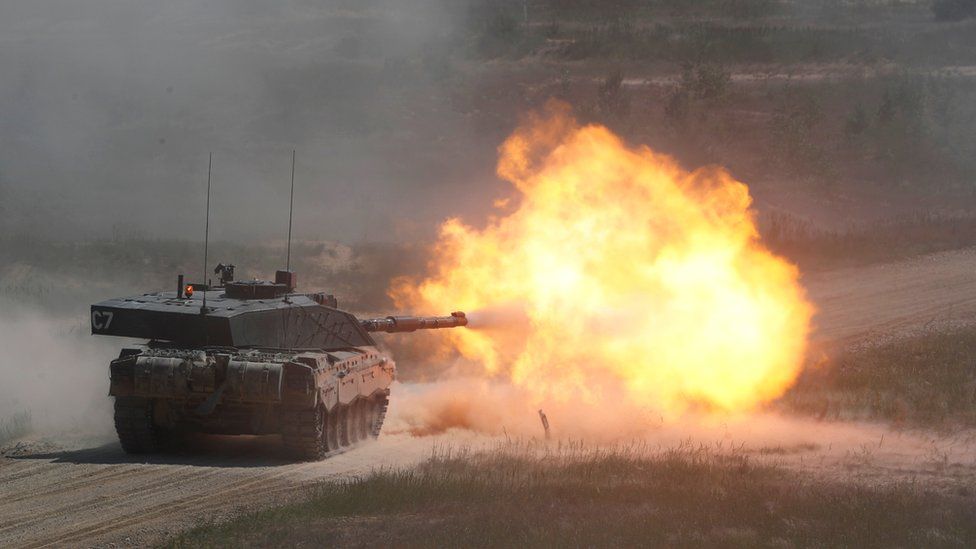 A tank fires with a flaming blast from the cannon caught on camera in this photo