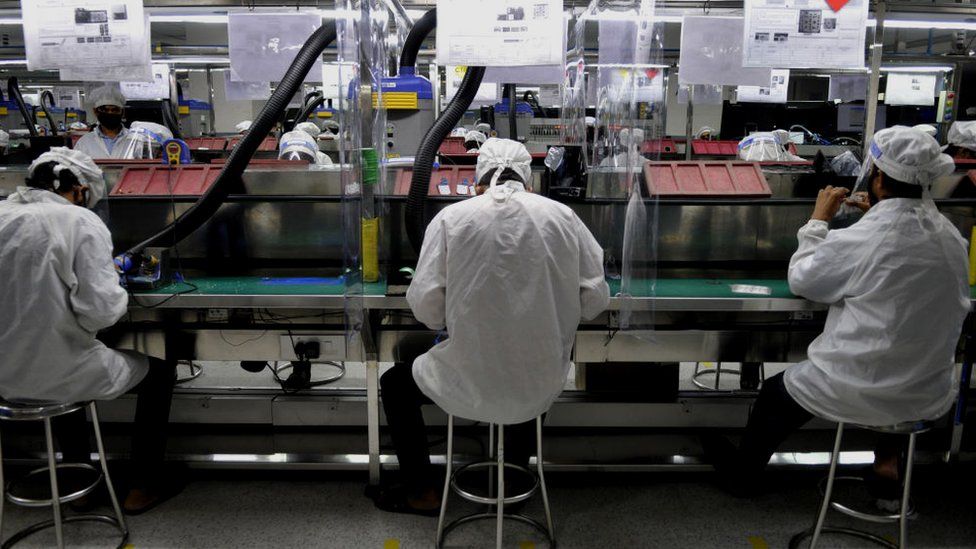 Workers at a mobile factory in Noida