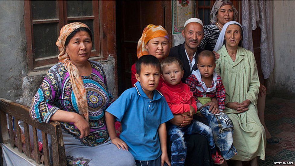 Uighur family pictured outside their home