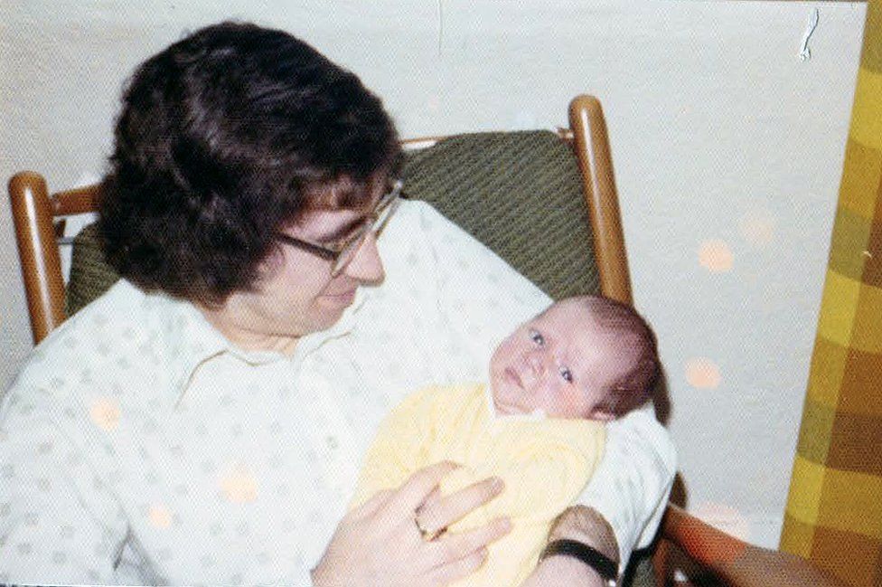 Don Cunningham holding his newborn son, Iain