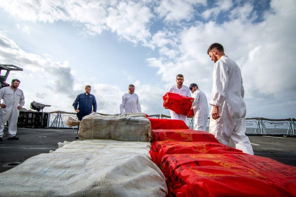 Royal Navy officers lay out the drugs haul on the frigate