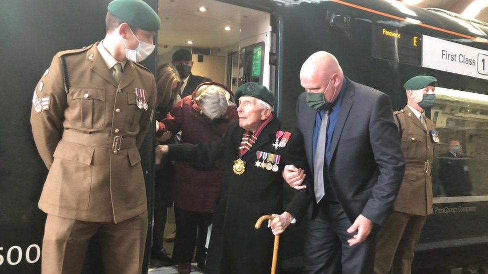 Harry Billinge stood next to army officer next to train