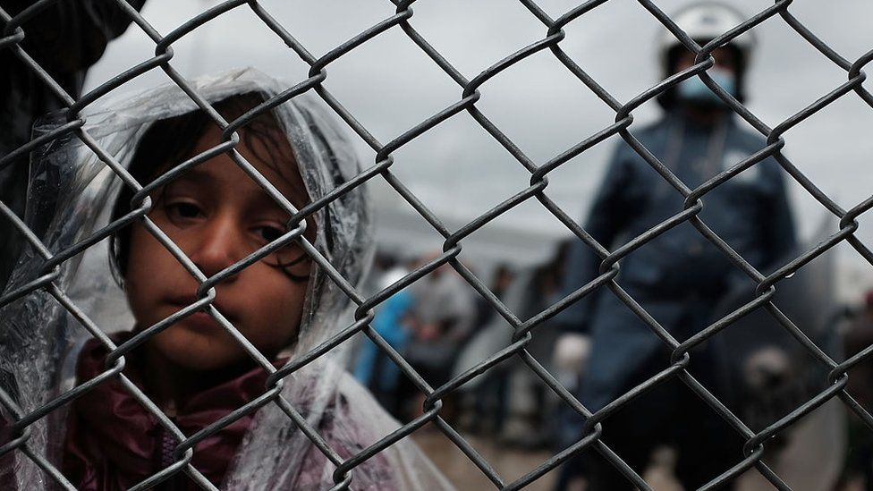 A child waits at the migrant processing centre on the island of Lesbos